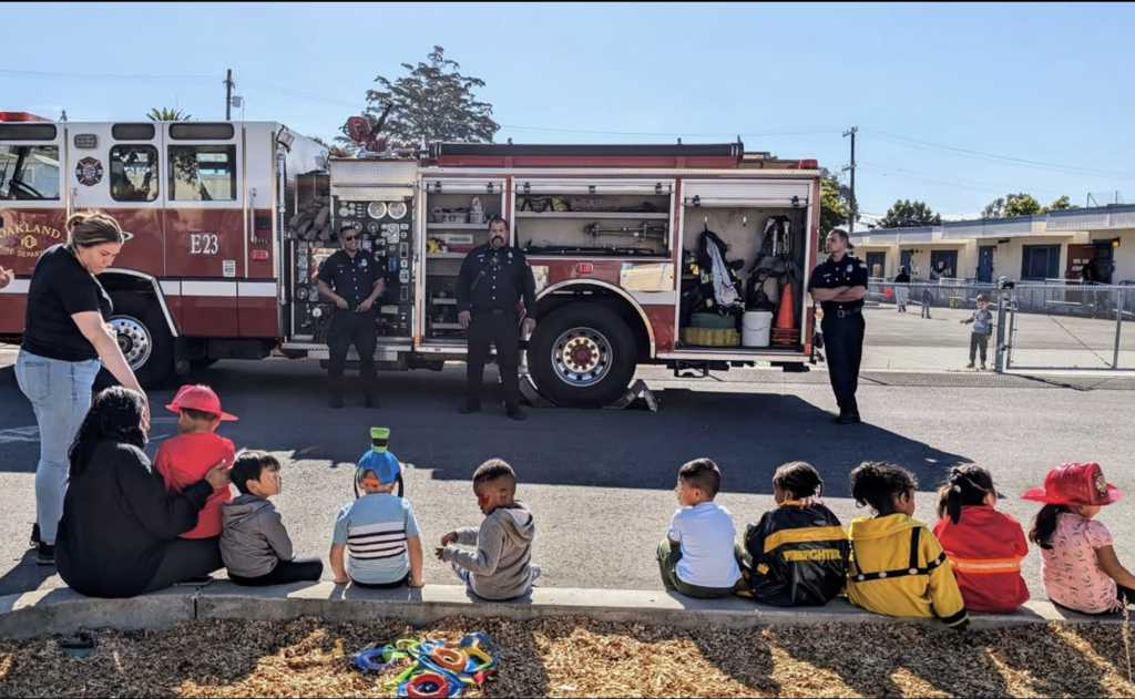 East Bay Afterschool Program — Community outing with Oakland firefighters Energetic preschoolers in a library enjoy bubbles and storytelling during an interactive group session.